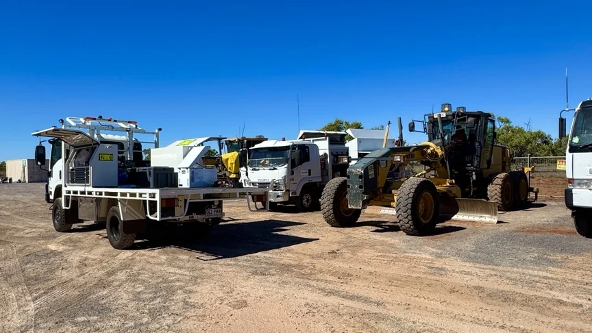 Two 12Mech service trucks and a grader on a civil worksite